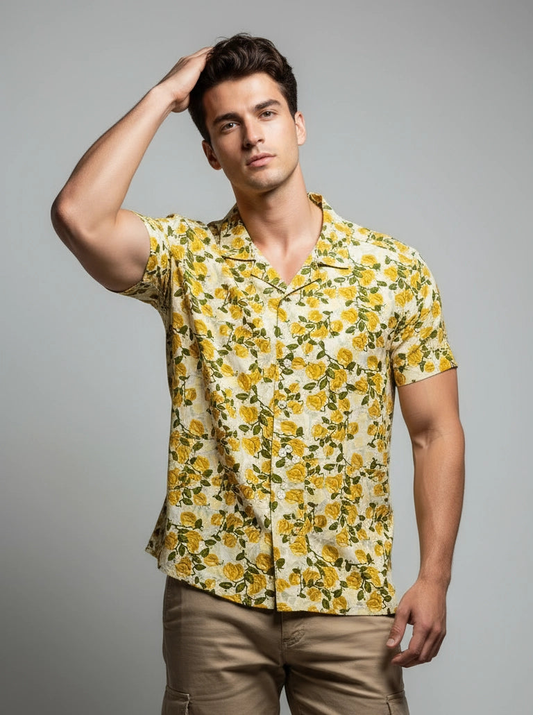 Man wearing a yellow floral shirt against a gray background