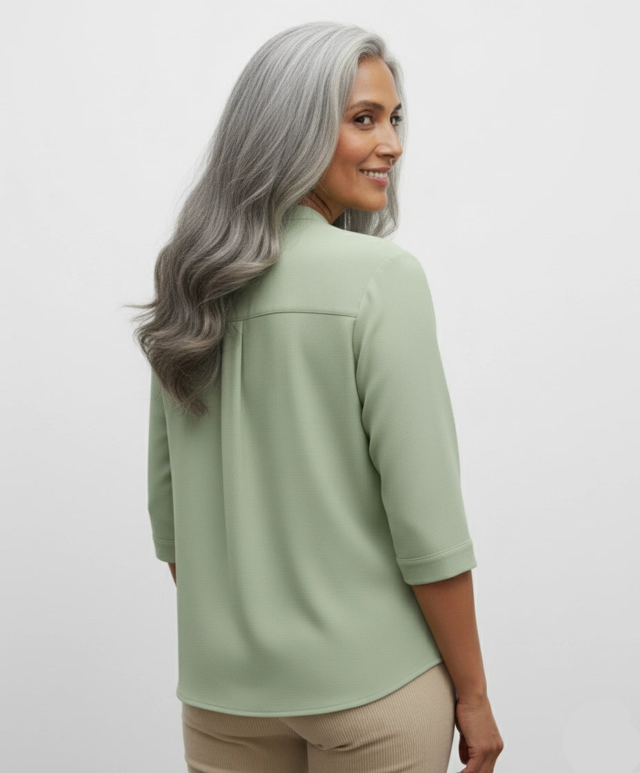 Woman wearing a Pista Light green shirt form women with two pockets, three fourth sleeves and mandarin collar.