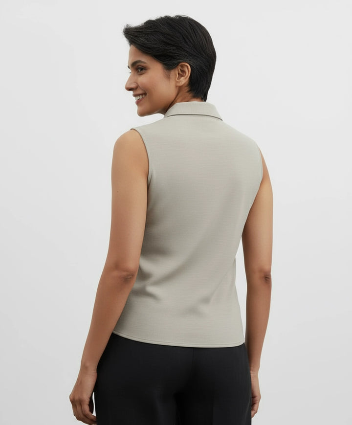 woman wearing Light beige sleeveless shirt for women. spread collar.