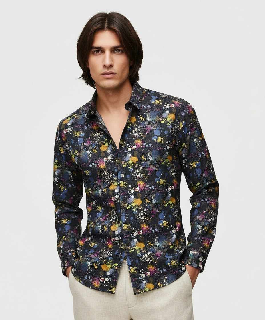 Man wearing black full sleeve men shirt with splatter and abstract pattern.