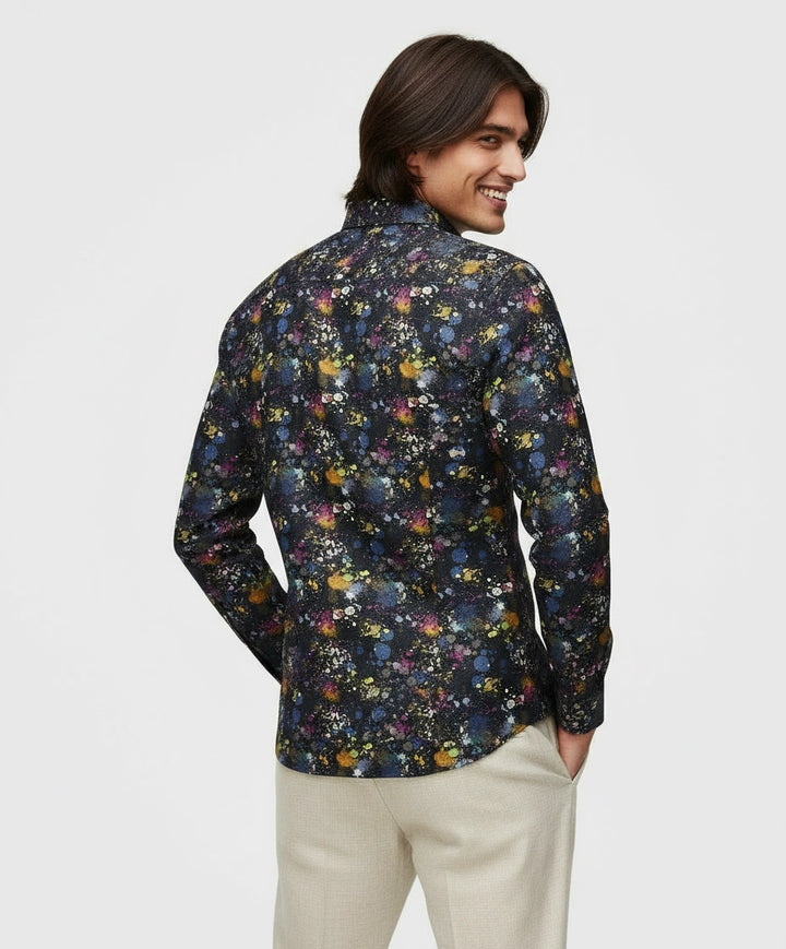 Man wearing black full sleeve men shirt with splatter and abstract pattern.