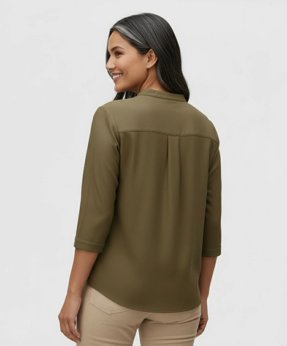 Woman wearing Dark brown Khaki shirt form women with two pockets, three fourth sleeves and mandarin collar.