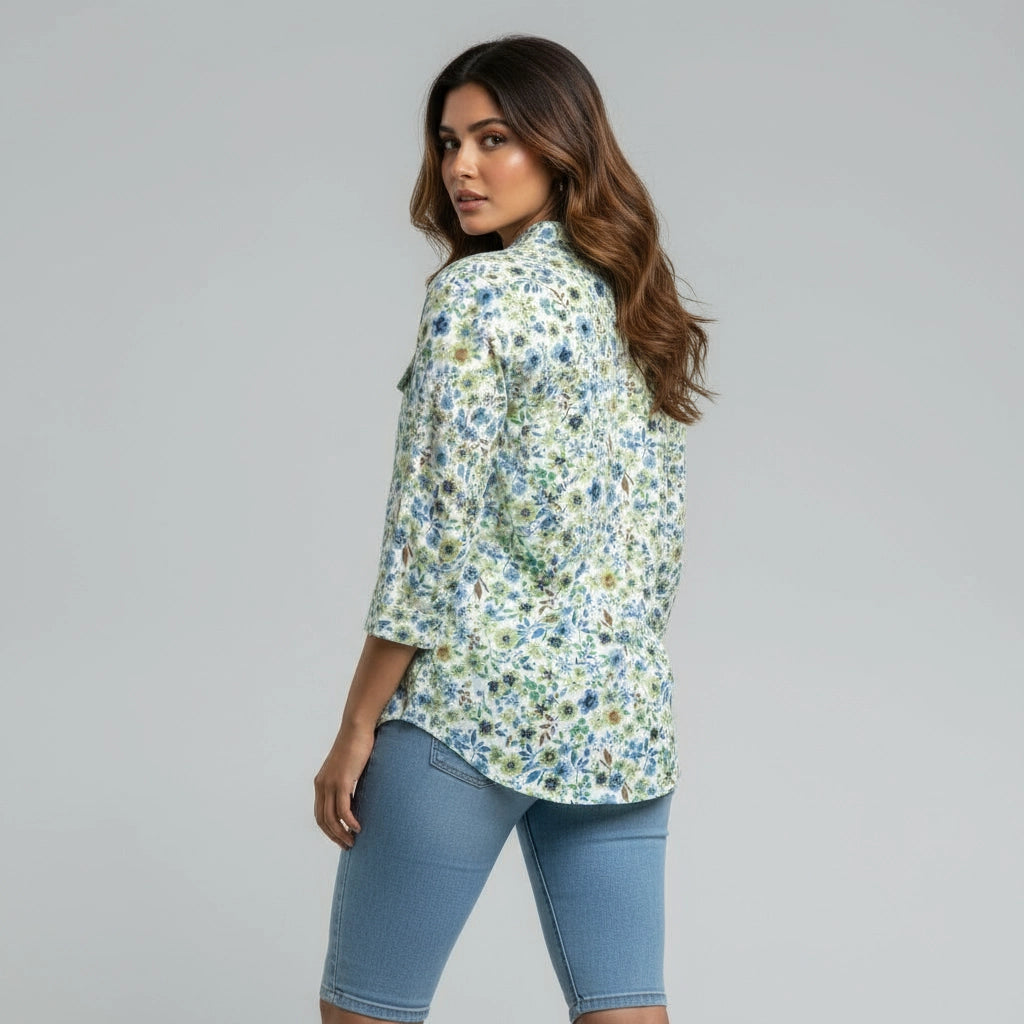 Woman wearing white blue and green floral women shirt, mandarin collar, three fourth sleeves