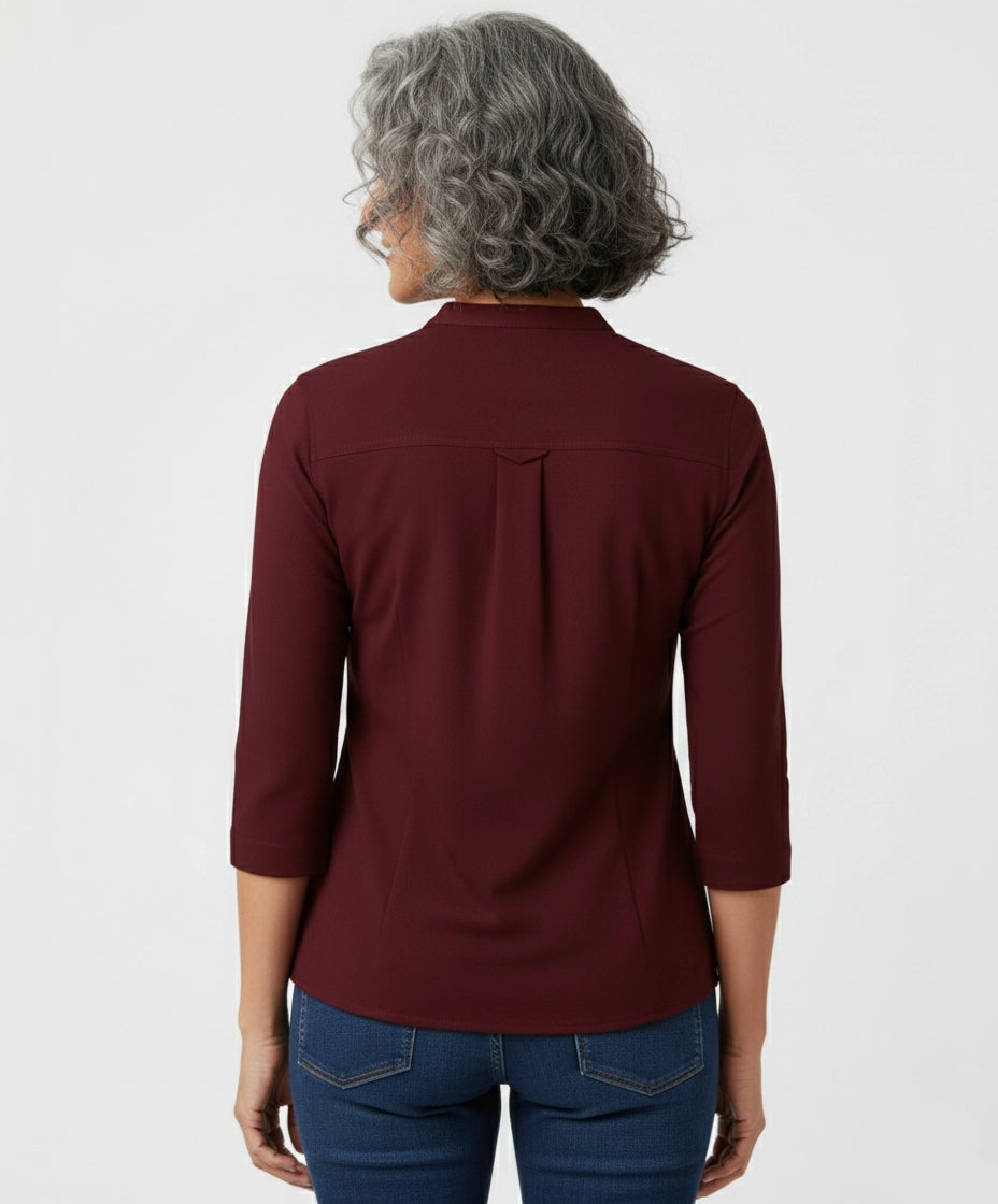 Woman wearing a burgundy Berry Maroon shirt for women, mandarin collar, three fourth sleeves. two pockets.