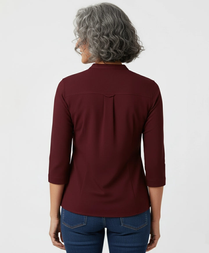 Woman wearing a burgundy Berry Maroon shirt for women, mandarin collar, three fourth sleeves. two pockets.