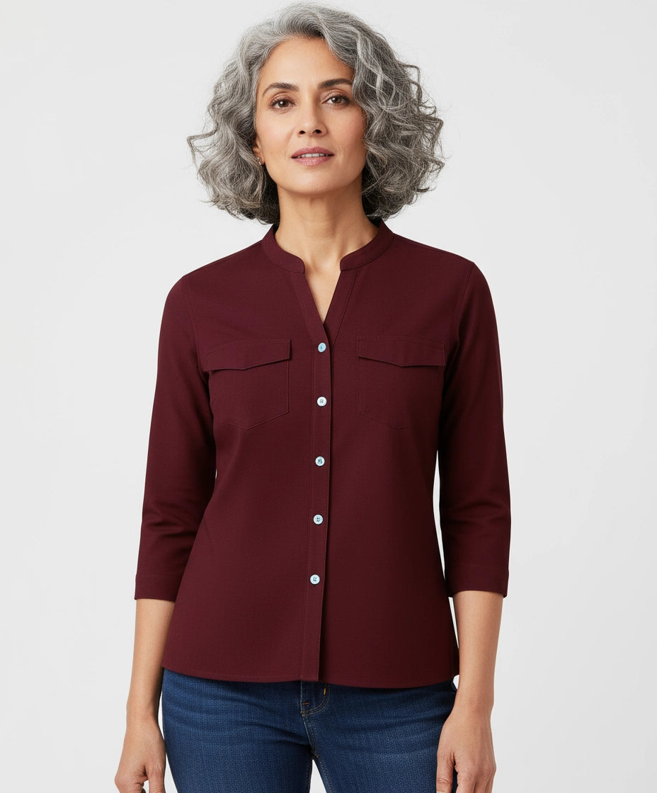Woman wearing a burgundy Berry Maroon shirt for women, mandarin collar, three fourth sleeves. two pockets.