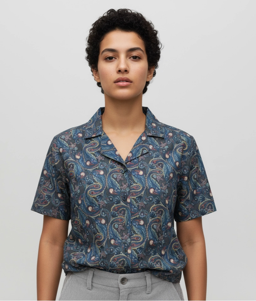 Woman wearing a Short-sleeve women shirt with a blue and black paisley pattern. Cuban Collar