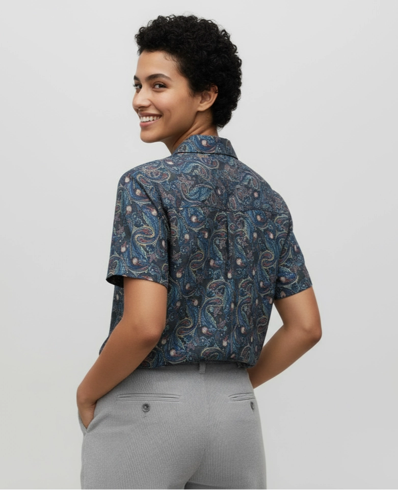 Woman wearing a Short-sleeve women shirt with a blue and black paisley pattern. Cuban Collar