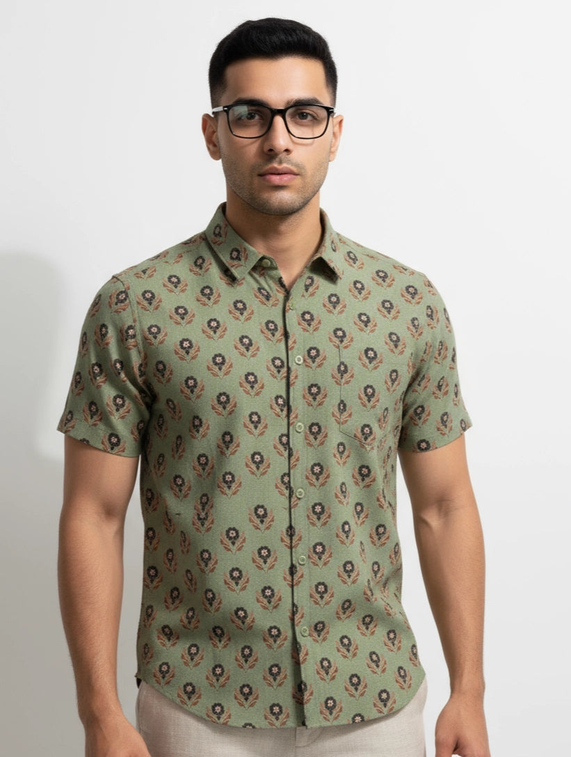 Man wearing alight Green olive pista color floral and geometric patterned men shirt. short sleeve, spread regular collar